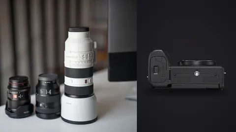 Sony a6700 product photo beside three camera lenses on a desk, a white Sony telephoto lens at right