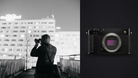 Fujifilm X-E5 product photo beside photographer shooting handheld on a rooftop walkway at night