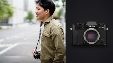 Fujifilm X-T30 III product photo beside street photographer smiling and holding a compact camera on a city sidewalk