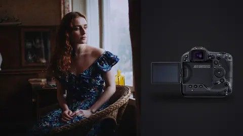 Canon EOS R3 product photo beside woman in floral dress seated in armchair by window