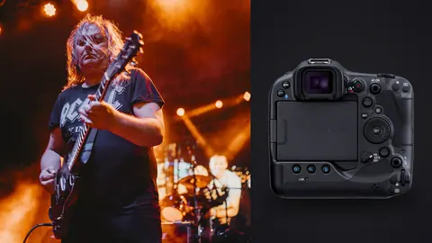 Canon EOS R3 product photo beside guitarist performing on stage under orange lights