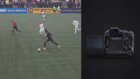 Canon EOS R3 product photo beside soccer players chasing the ball across a stadium pitch