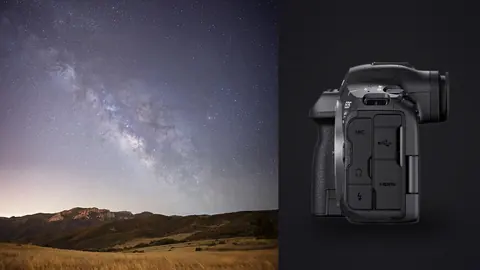 Canon EOS R5 Mark II product photo beside milky way arching over a grassy mountain ridge at dusk light