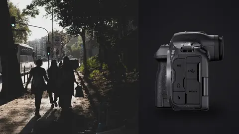 Canon EOS R5 Mark II product photo beside people walking along a sunlit tree lined path