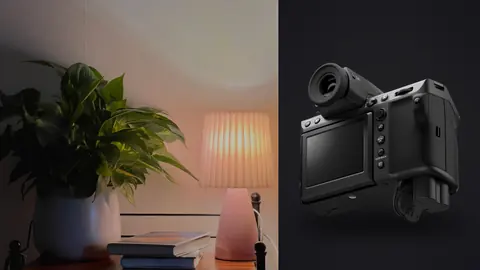 Fujifilm GFX100 II product photo beside cozy room corner with plant and warm lamp