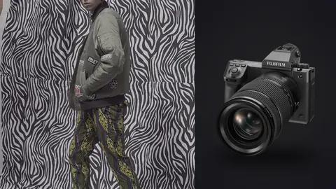 Fujifilm GFX100 II product photo beside man in a bomber jacket and patterned trousers against a zebra print backdrop