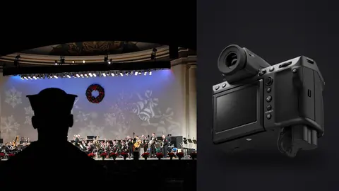 Fujifilm GFX100 II product photo beside silhouette of a person watching an orchestra perform on stage