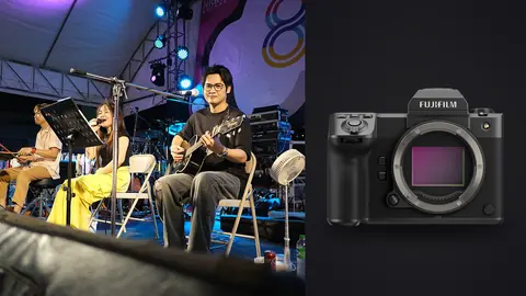 Fujifilm GFX100 II product photo beside two musicians performing seated on stage