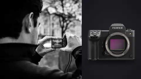 Fujifilm GFX100 II product photo beside person photographing a canal scene with a phone