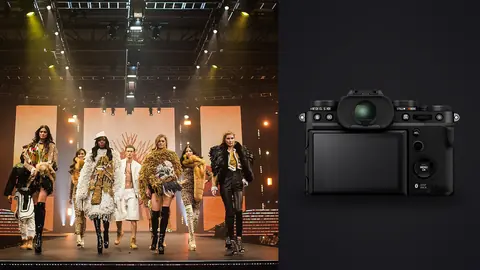 Fujifilm X-T5 product photo beside group of models in elaborate feathered tribal-inspired outfits on stage