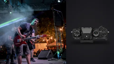 Fujifilm X-T5 product photo beside guitarist performing at outdoor festival with crowd