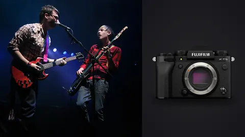 Fujifilm X-T5 product photo beside two guitarists performing on stage