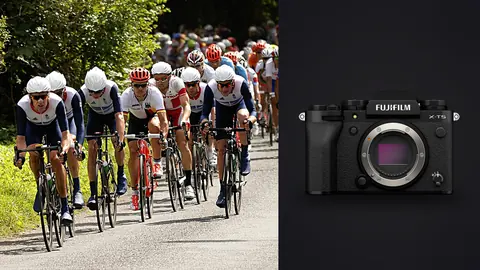 Fujifilm X-T5 product photo beside peloton of national team cyclists racing past cheering fans