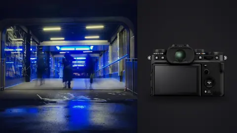 Fujifilm X-T5 product photo beside blurred figures walking through a blue-lit underpass at night