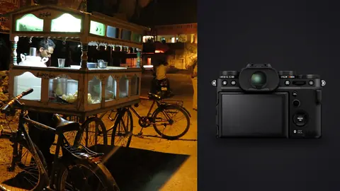 Fujifilm X-T5 product photo beside street food vendor at a night cart with parked bicycles