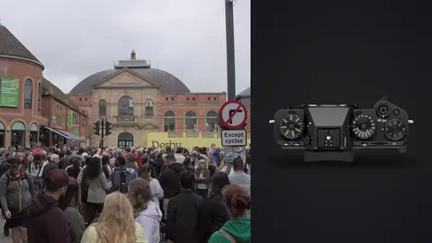 Fujifilm X-T5 product photo beside large crowd gathered before a domed market hall