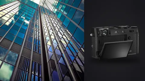 Fujifilm X100VI product photo beside upward view of glass skyscraper facade