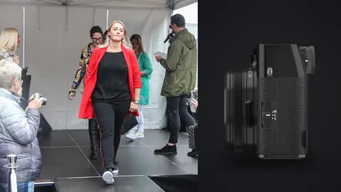 Fujifilm X100VI product photo beside model in a red blazer and black outfit walking a runway