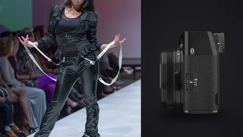 Fujifilm X100VI product photo beside model in a dark textured outfit posing dynamically on a runway