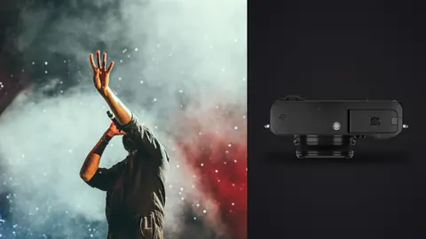 Fujifilm X100VI product photo beside silhouette of performer with raised hand and colorful smoke