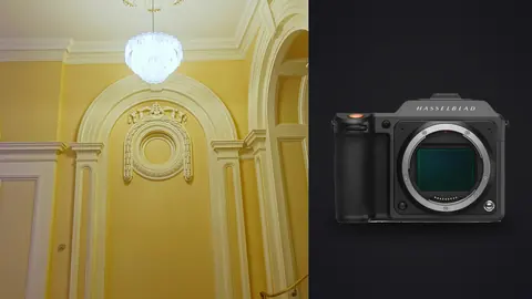 Hasselblad X2D 100C product photo beside grand yellow hall with ornate archway and chandelier
