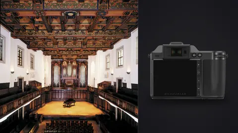 Hasselblad X2D 100C product photo beside ornate wood-beamed concert hall with rows of seating