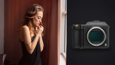 Hasselblad X2D 100C product photo beside woman in black slip dress by window curtain