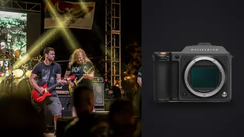 Hasselblad X2D 100C product photo beside guitarists performing on stage with dramatic lighting
