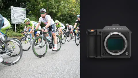 Hasselblad X2D 100C product photo beside cyclists in team kits racing around a rural road bend
