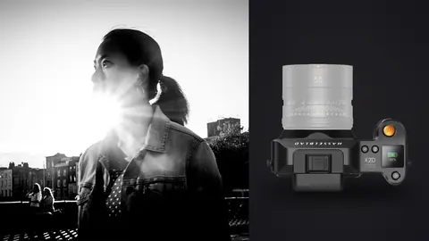 Hasselblad X2D 100C product photo beside woman backlit by sunset on a rooftop terrace over the city