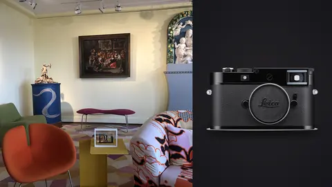 Leica M11 product photo beside eclectic gallery living room with colorful chairs and framed art