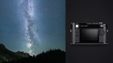 Leica M11 product photo beside milky way arching vertically over a dark mountain ridge