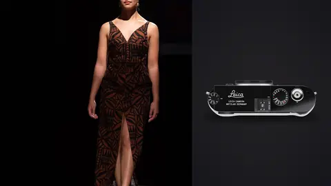 Leica M11 product photo beside model in a brown patterned gown with a thigh slit