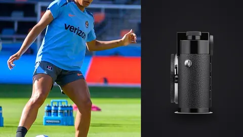 Leica M11 product photo beside soccer player kicking a ball on a stadium pitch