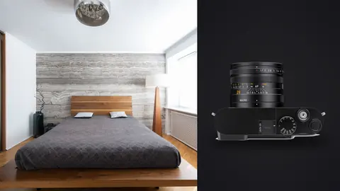 Leica Q3 product photo beside minimalist bedroom with stone accent wall