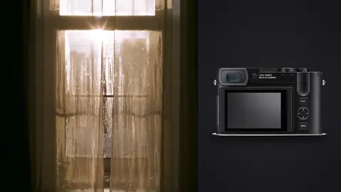 Leica Q3 product photo beside door with sunburst through lace curtain