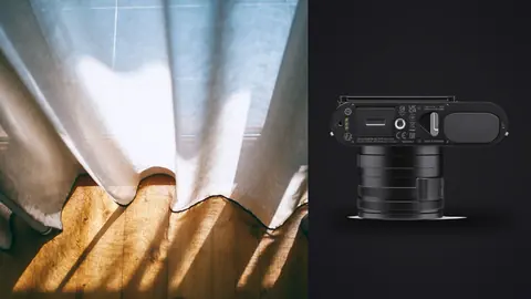 Leica Q3 product photo beside curtain fabric with dramatic golden light rays
