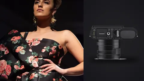 Leica Q3 product photo beside model in an off-shoulder floral dress posing