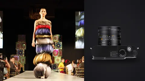 Leica Q3 product photo beside model wearing an elaborate layered textile headpiece on a runway