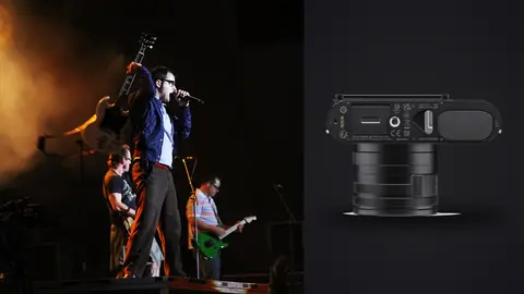 Leica Q3 product photo beside two musicians performing on stage with dramatic lighting