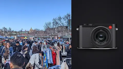 Leica Q3 product photo beside shoppers browsing racks of clothes at an outdoor flea market