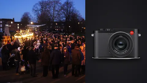 Leica Q3 product photo beside evening crowd gathered by a lit cathedral market