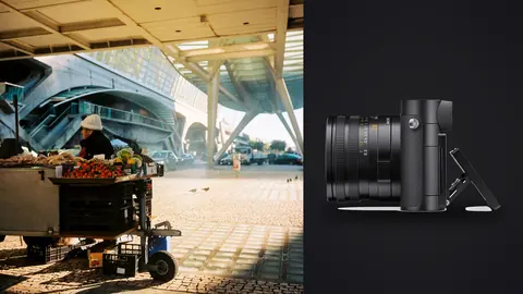 Leica Q3 product photo beside vendor cart under a modern glass and steel canopy
