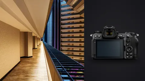 Nikon Z6 III product photo beside modern atrium with dramatic staircase and geometric lines