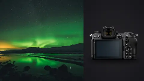 Nikon Z6 III product photo beside green aurora reflected in a still lake beside mountains