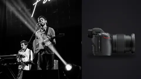 Nikon Z6 III product photo beside band performing on stage in black and white