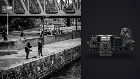 Nikon Z6 III product photo beside two people walking along a riverside promenade