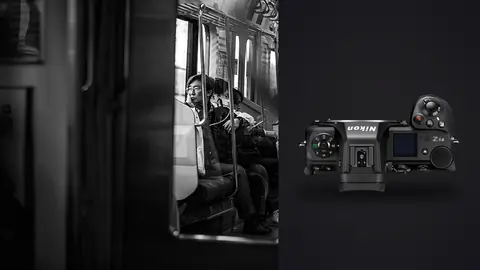 Nikon Z6 III product photo beside passengers reflected in a train window