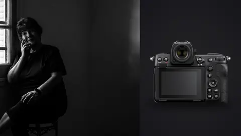 Nikon Z8 product photo beside older woman seated by window, hand to chin