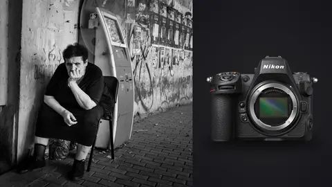 Nikon Z8 product photo beside elderly man sitting against a graffiti covered wall